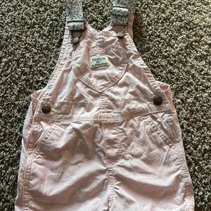 light pink Osh Kosh B'gosh overalls with blue floral straps and heart pocket 2T